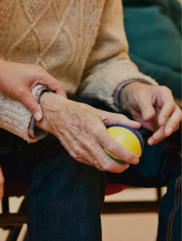 elderly person holding ball
